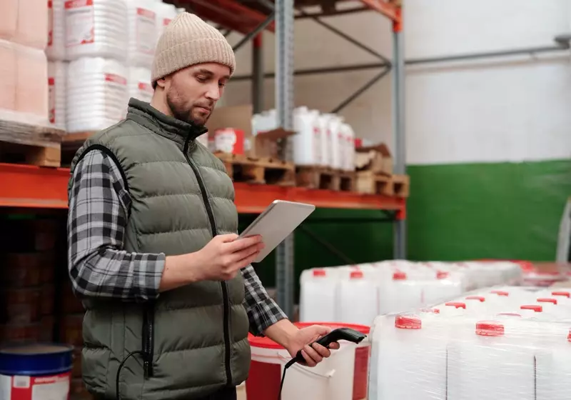 Operador de almacén tomando inventario con una tableta
